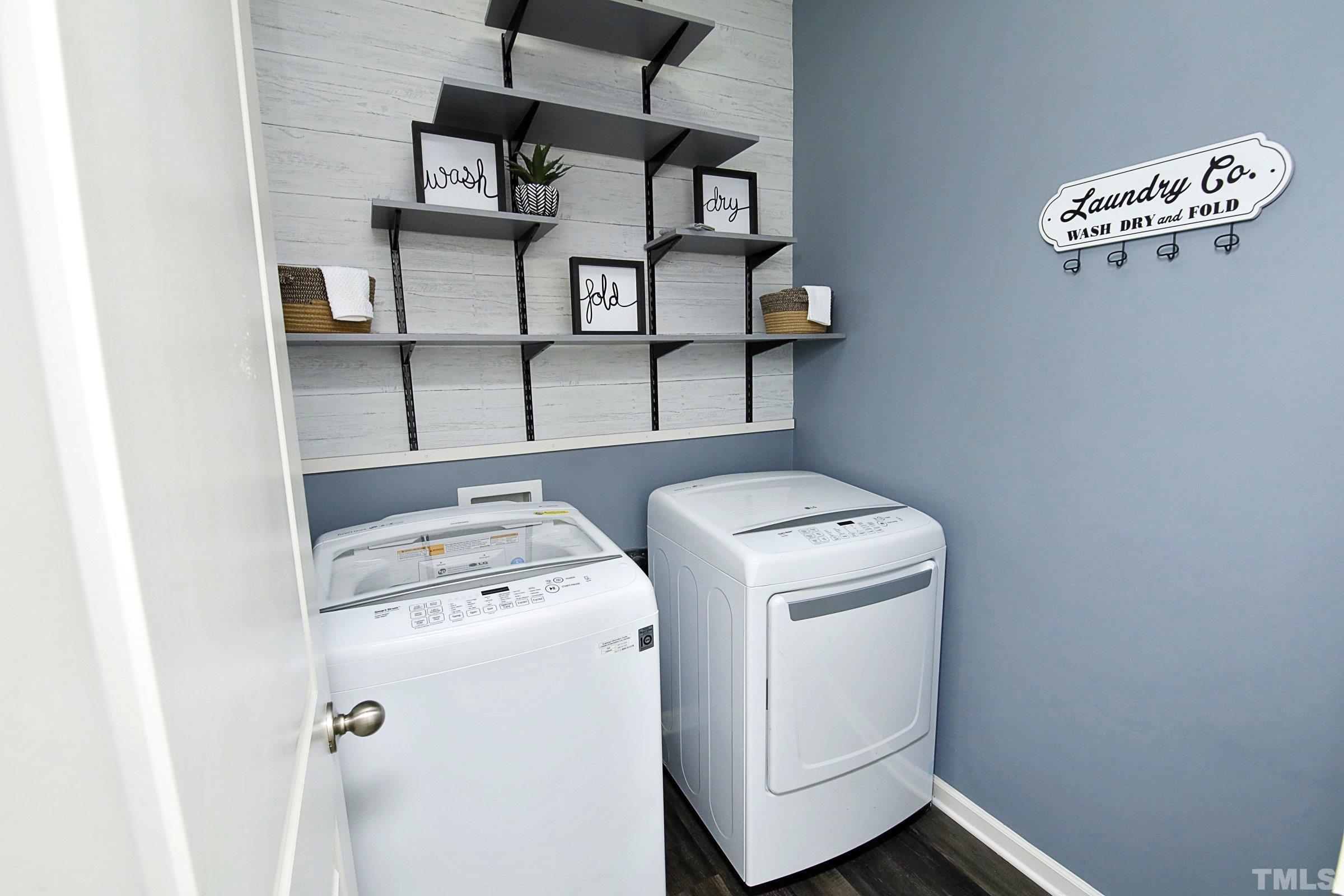 3617 Waleback Lane Raleigh, NC 27610 - Photo 16 of 34 a utility room with dryer washer and a view of living room