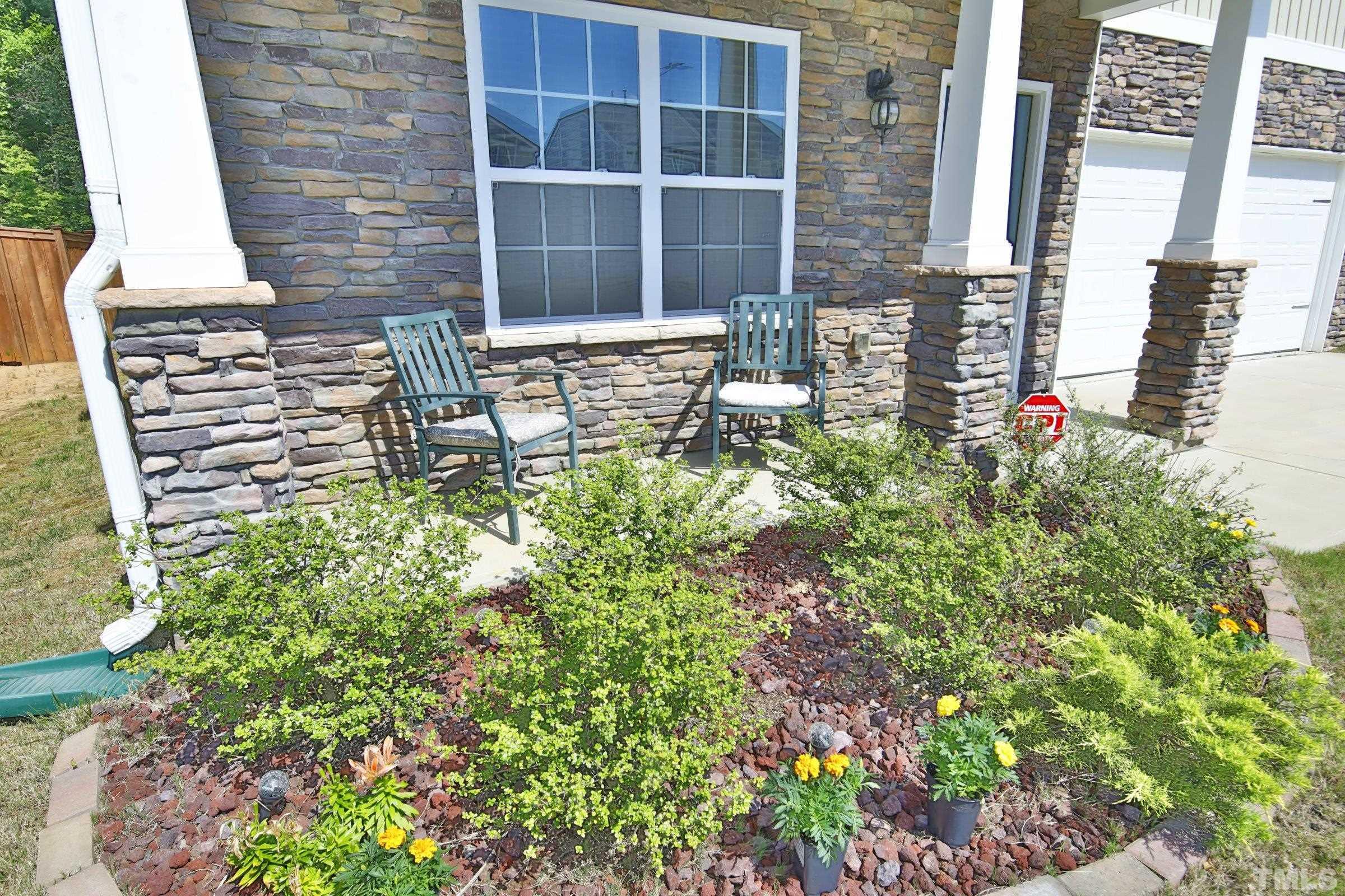3617 Waleback Lane Raleigh, NC 27610 - Photo 2 of 34 a flower garden in front of a building