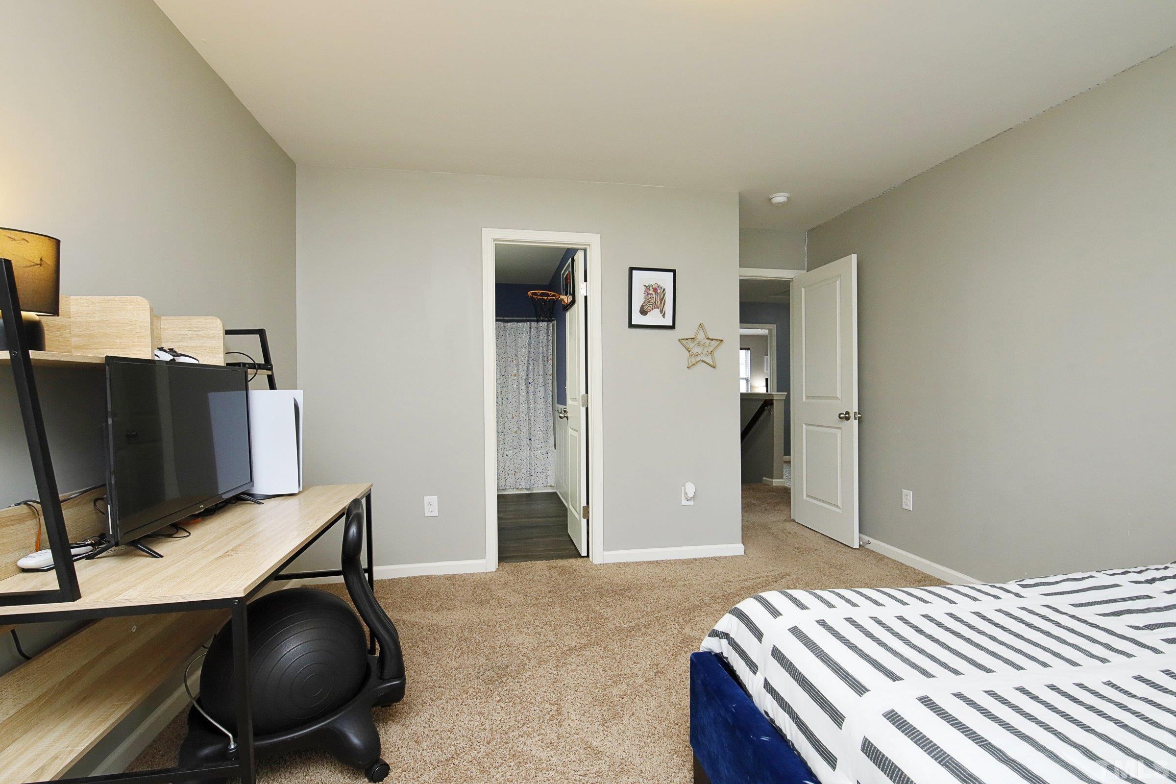 3617 Waleback Lane Raleigh, NC 27610 - Photo 27 of 34 a bedroom with bed and a large window
