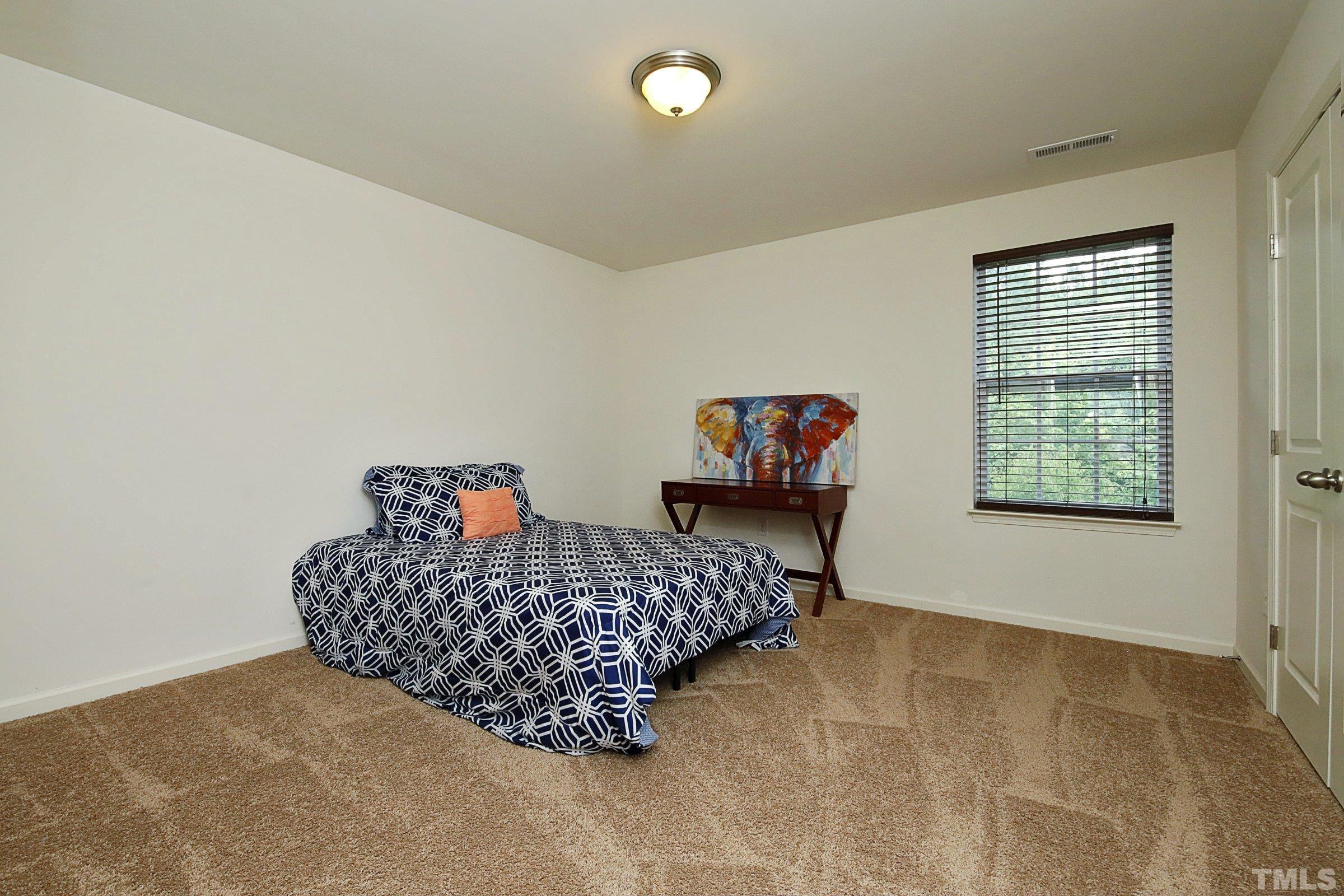 3617 Waleback Lane Raleigh, NC 27610 - Photo 29 of 34 a living room with furniture a rug and a window