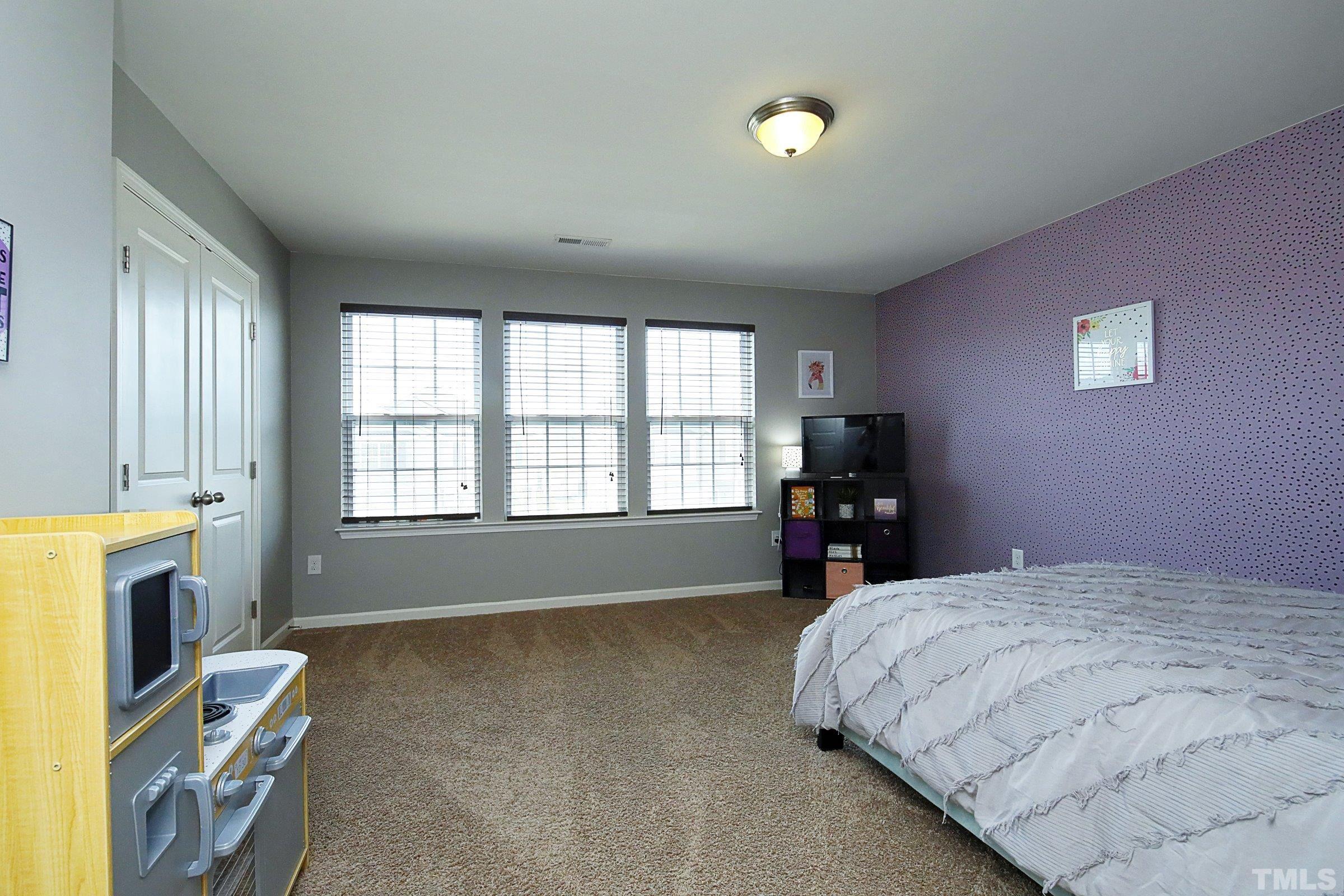 3617 Waleback Lane Raleigh, NC 27610 - Photo 30 of 34 a bedroom with a bed and a tv