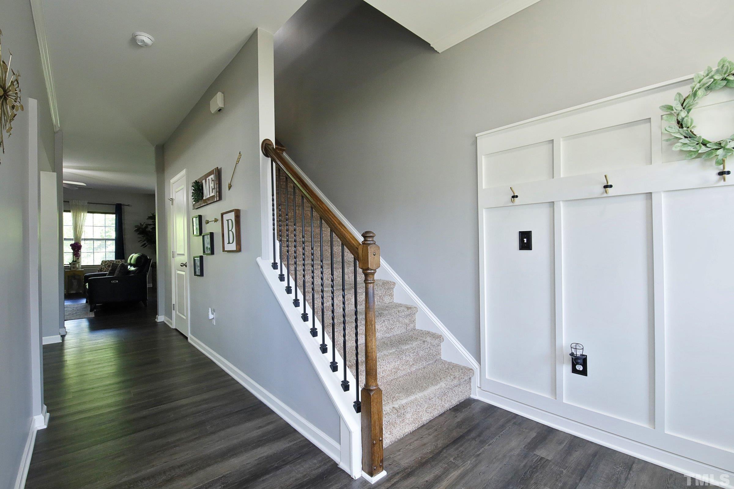 3617 Waleback Lane Raleigh, NC 27610 - Photo 4 of 34 a view of a hallway with wooden floor and staircase
