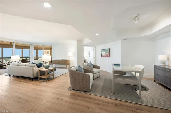 a living room with furniture and a wooden floor