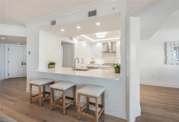 a kitchen with cabinets and wooden floor