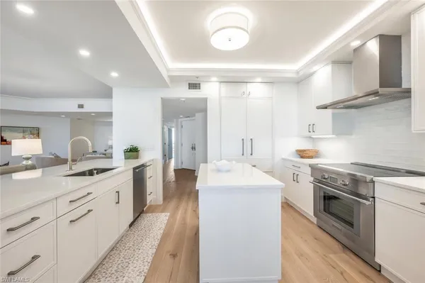 a kitchen with stainless steel appliances granite countertop a sink stove and refrigerator