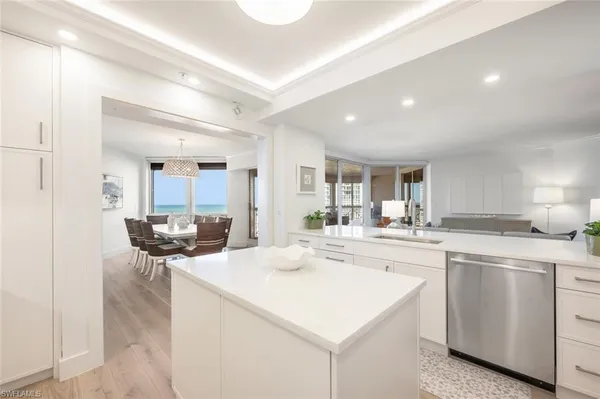 a dining room with furniture a chandelier and wooden floor