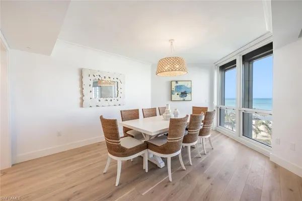 a view of a dining room with furniture wooden floor and chandelier