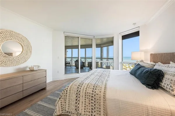a bedroom with a large bed and a chandelier