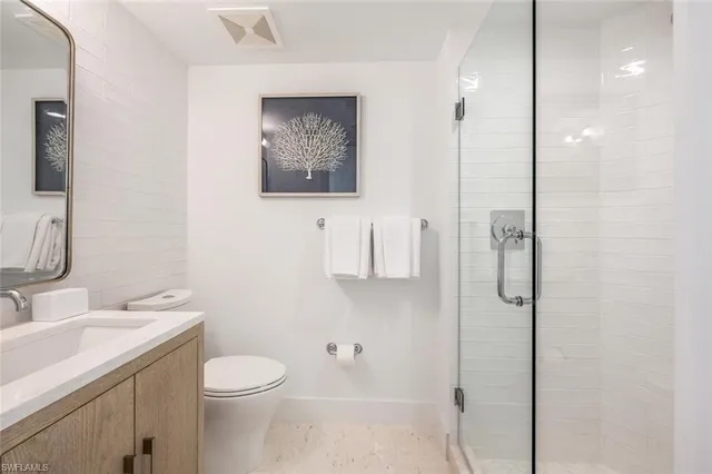 a bedroom with two beds and a lamp on the dresser