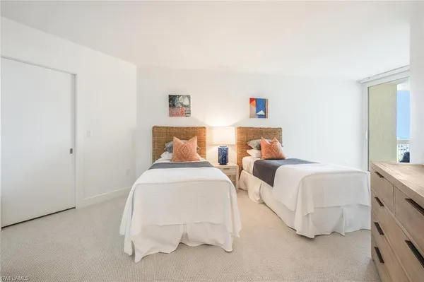 a large bed sitting in a bedroom and dresser