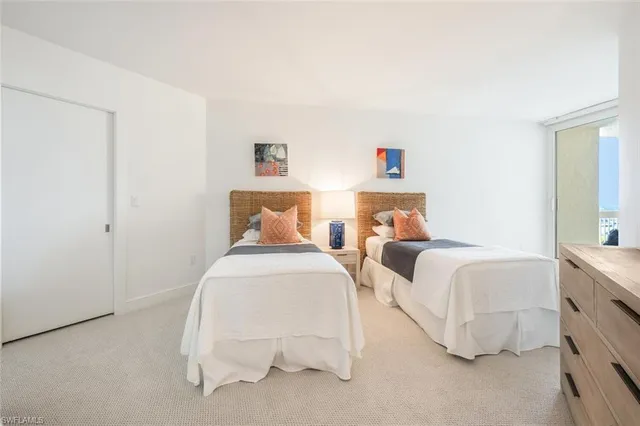 a large bed sitting in a bedroom and dresser