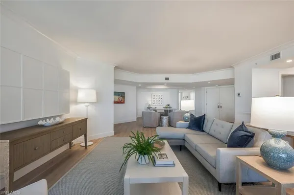 a living room with furniture and floor to ceiling windows