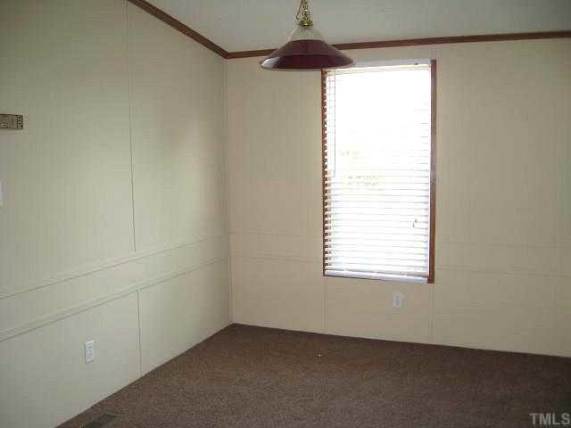 2585 Lucy Garrett Road Timberlake, NC 27583 - Photo 3 of 12 an empty room with a window