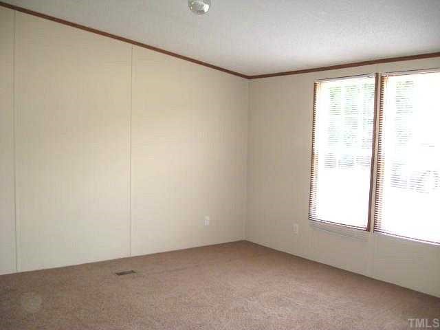 2585 Lucy Garrett Road Timberlake, NC 27583 - Photo 6 of 12 an empty room with a window