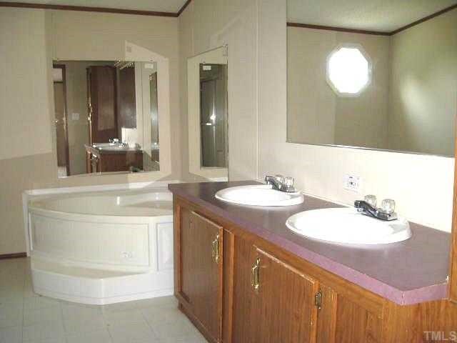 2585 Lucy Garrett Road Timberlake, NC 27583 - Photo 7 of 12 a bathroom with a sink and a mirror