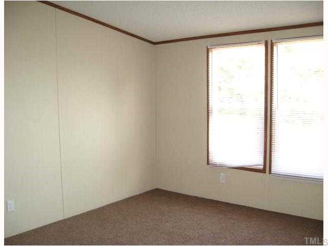 2585 Lucy Garrett Road Timberlake, NC 27583 - Photo 10 of 12 an empty room with a window