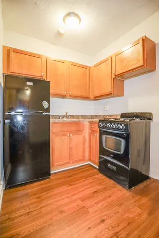 a kitchen with granite countertop a stove and a refrigerator