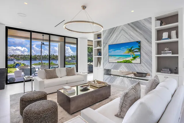 a spacious bedroom with furniture and a large window