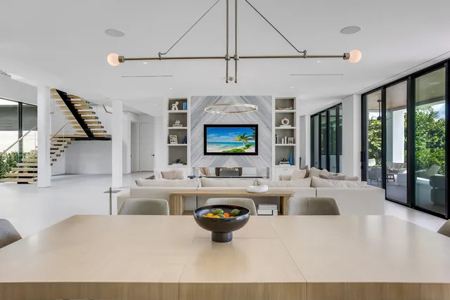 a living room with fireplace furniture and a large window