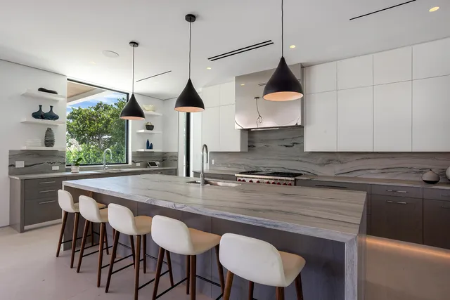 a living room with furniture a rug and a chandelier