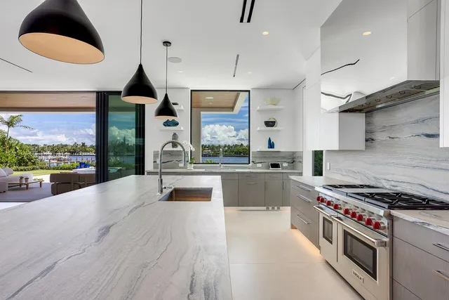 a view of a house with brick walls and plants