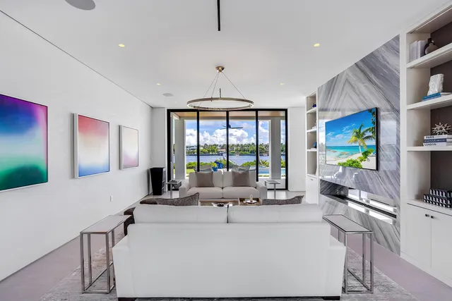 a view of a house next to a lake with a large trees