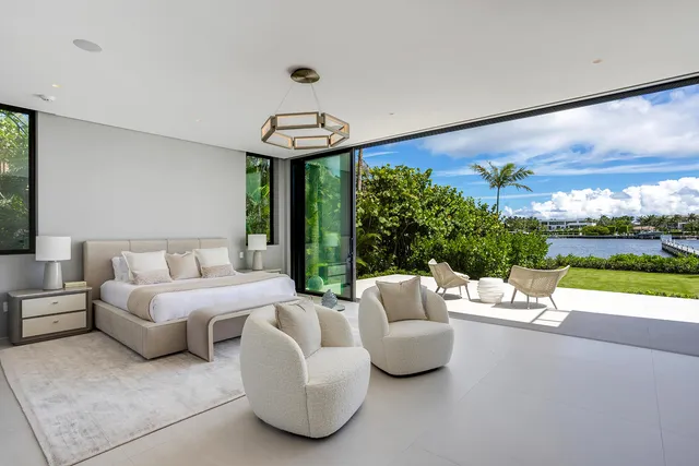an aerial view of a house with a yard lake and outdoor seating