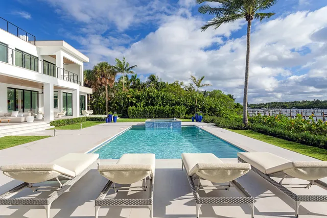 a view of a patio with couches table and chairs and potted plants