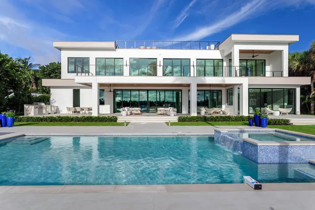 a living room with patio furniture and a large window