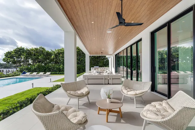 a bedroom with a bed and large windows