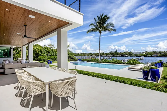 a bathroom with a granite countertop tub sink and mirror