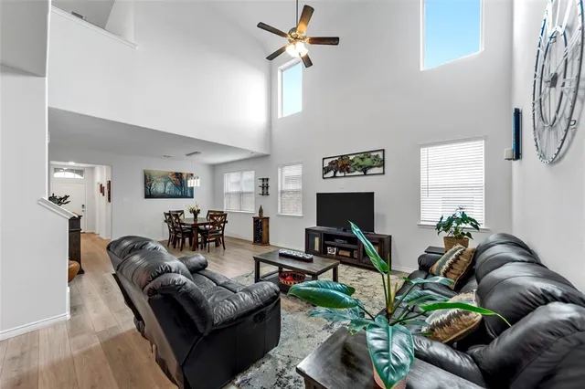 a living room with furniture potted plant and a wooden floor