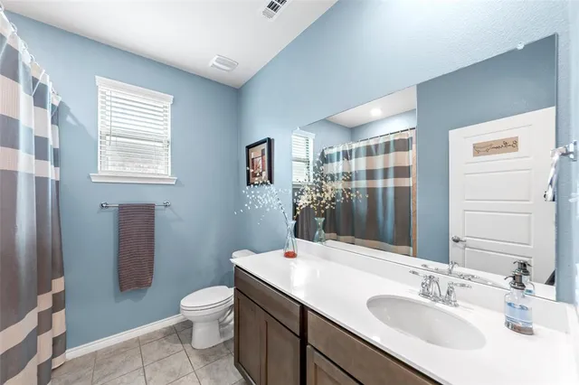 a bathroom with a granite countertop sink toilet a large mirror and shower