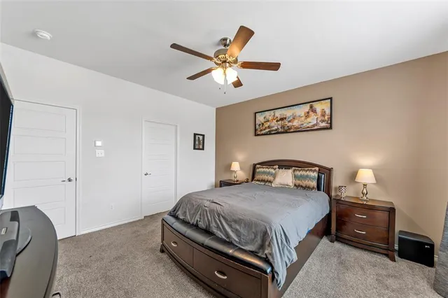 a bedroom with a bed and ceiling fan