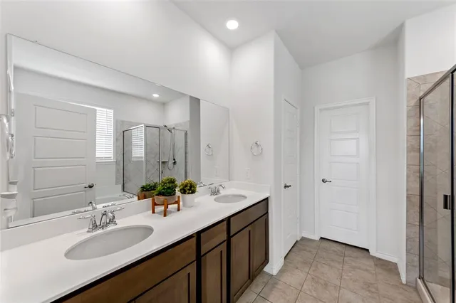 a bathroom with a sink double vanity granite and a mirror