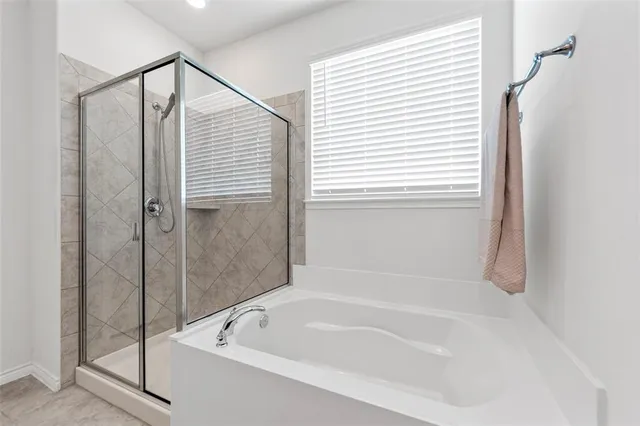 a bathroom with a bathtub and a shower