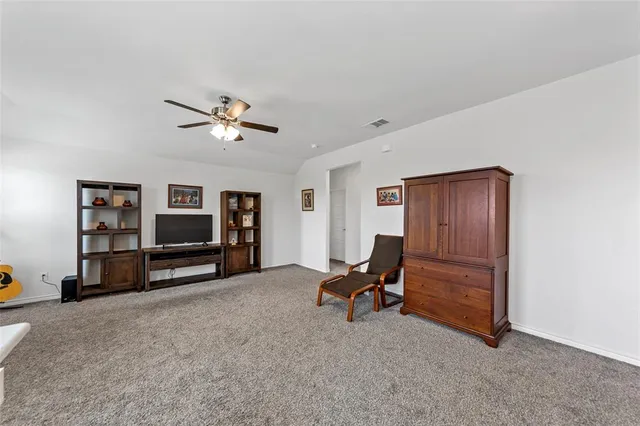 a view of workspace with furniture and ceiling fan