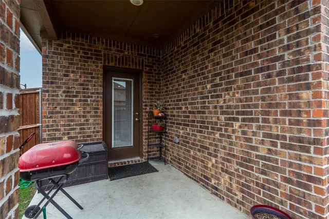 a view of a brick wall with seating space
