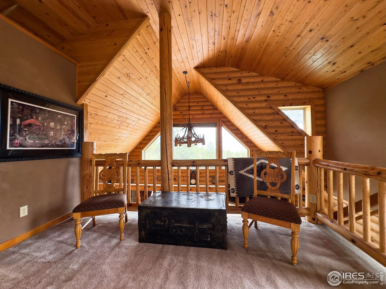 3676 Cherokee Meadows Road Livermore, CO 80536 - Photo 14 of 43 a living room with furniture and a wooden floor