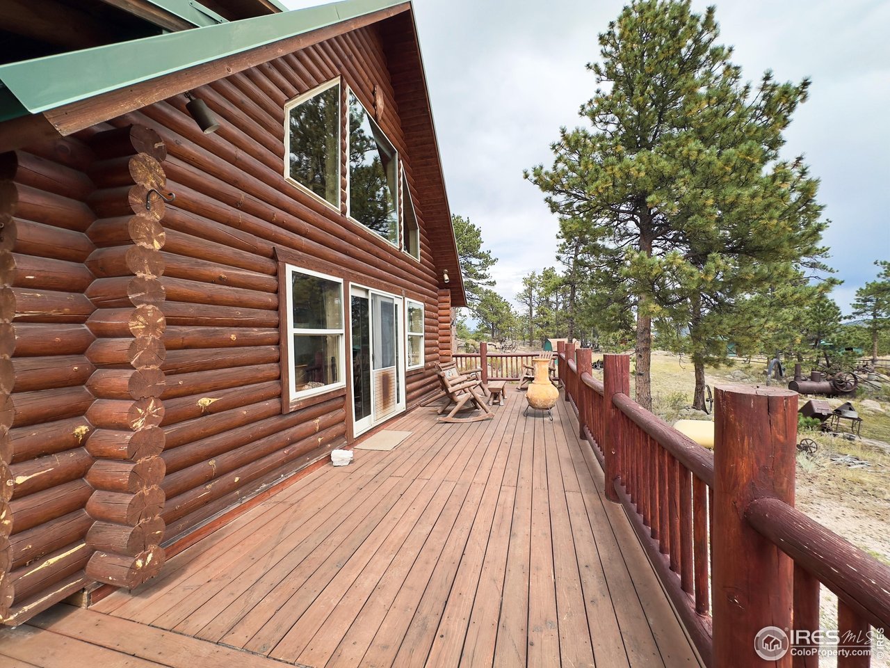 3676 Cherokee Meadows Road Livermore, CO 80536 - Photo 28 of 43 a view of house with wooden floor and outdoor seating