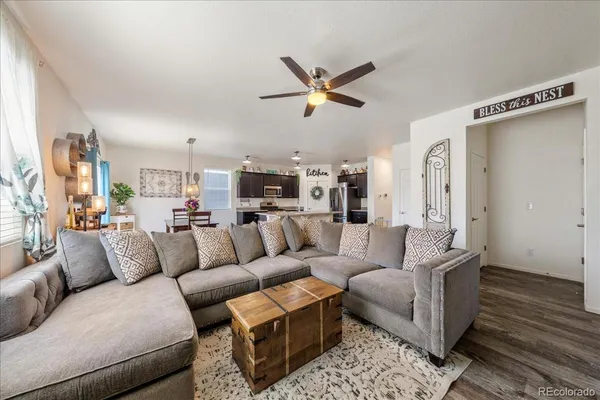 a kitchen with stainless steel appliances a dining table chairs stove refrigerator and cabinets