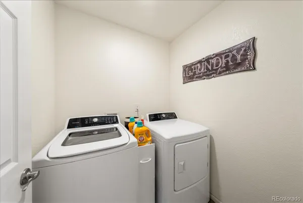 a bathroom with a double vanity sink toilet and shower