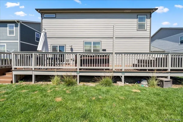 a view of a house with backyard and deck
