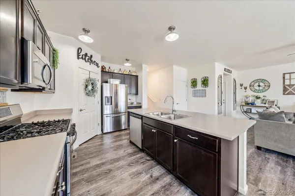 a large kitchen with a table chairs refrigerator and microwave
