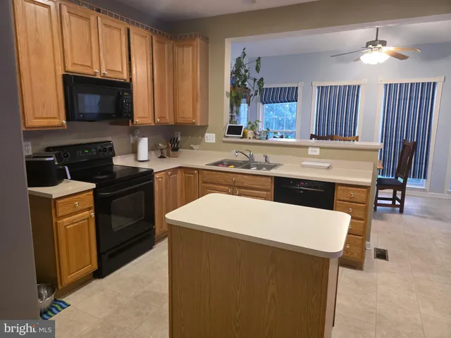 a kitchen with a sink stove and microwave