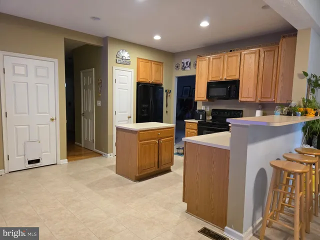 a kitchen with sink a refrigerator and cabinets
