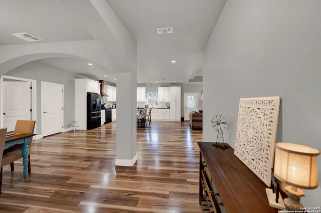 a view of a dining room with furniture wooden floor and chandelier