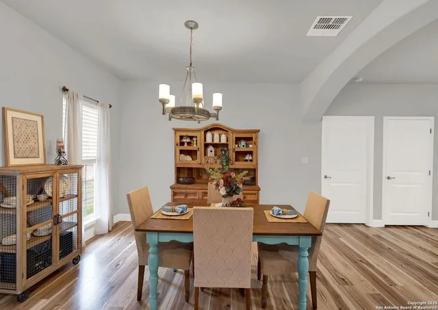 a view of a dining room with furniture and wooden floor