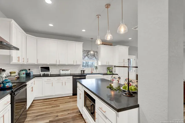 a kitchen with stainless steel appliances a stove a refrigerator and cabinets