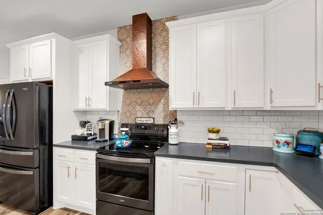a kitchen with stainless steel appliances granite countertop a sink a stove and a refrigerator